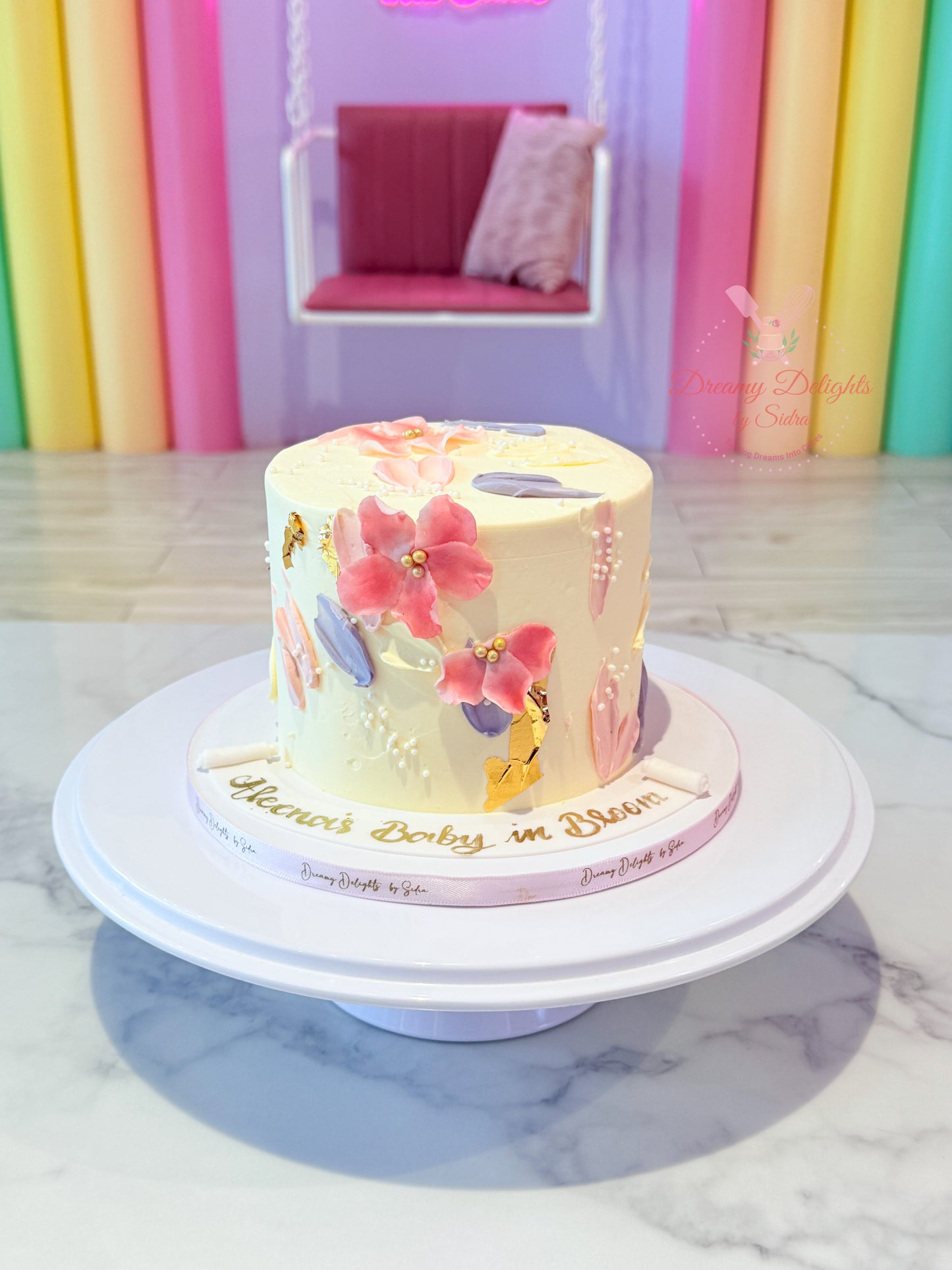 Decorative cake with floral designs on a marble surface with colorful background