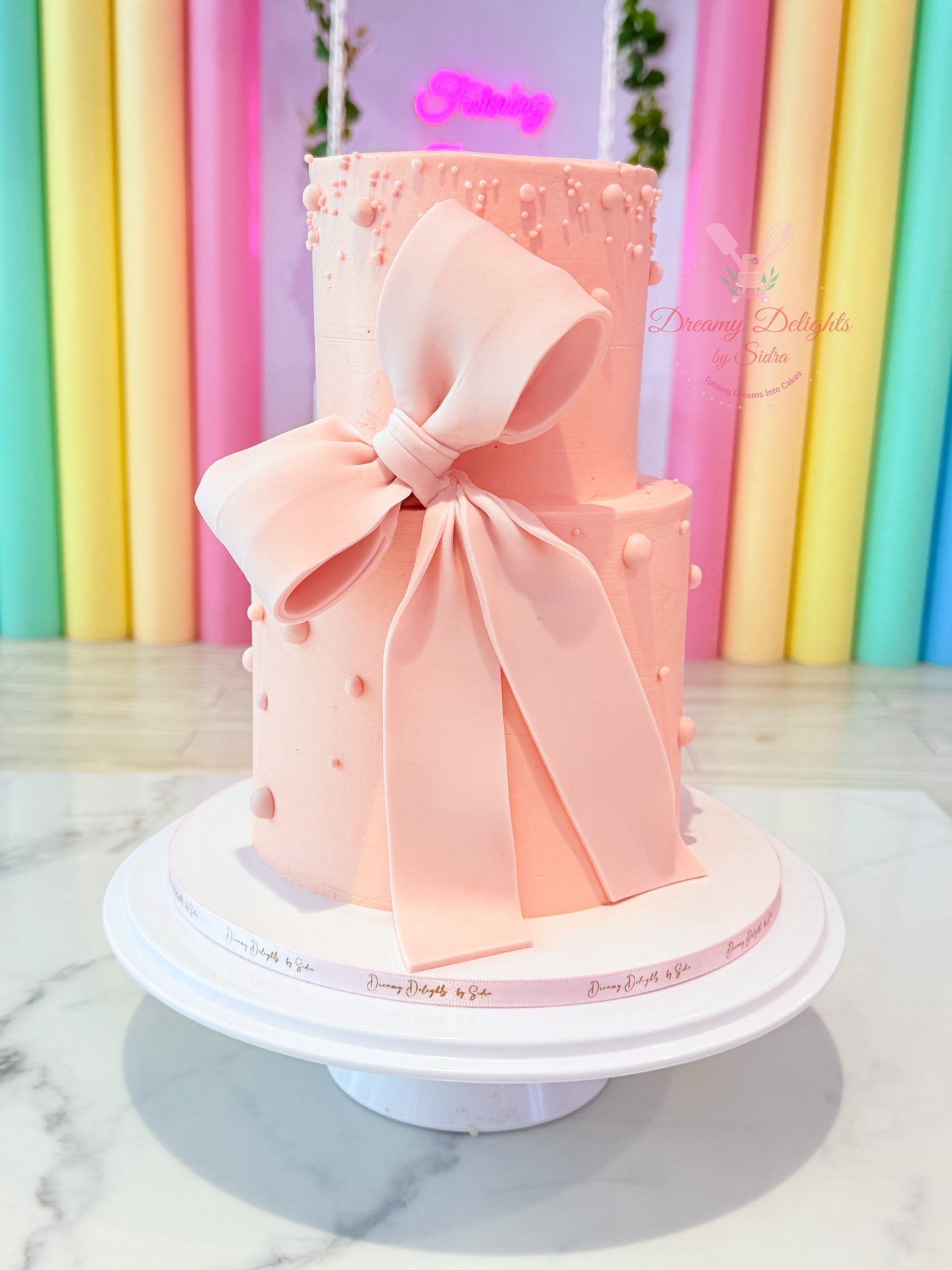 Big bow pink birthday cake for girls with elegant pastel design in Dubai