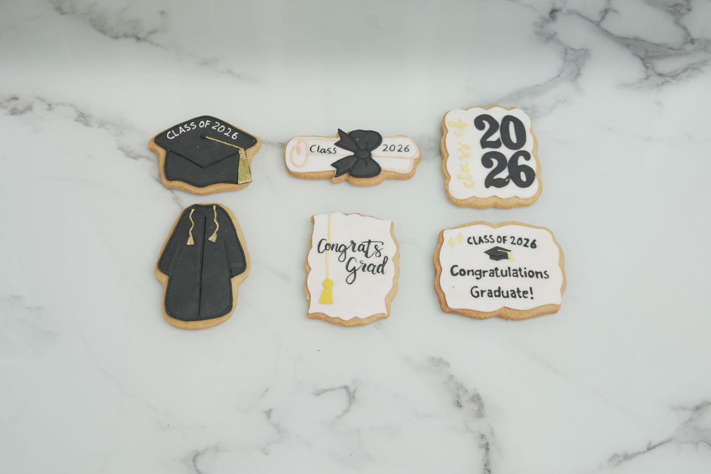 Class of 2026 graduation cookies with graduation cap, diploma, and graduation gown designs for school and university graduation celebrations in Dubai