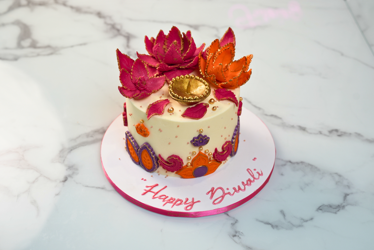 Diwali Light a Diya Cake with buttercream frosting, colourful fondant motifs and an inbuilt diya candle by Dreamy Delights by Sidra in Dubai