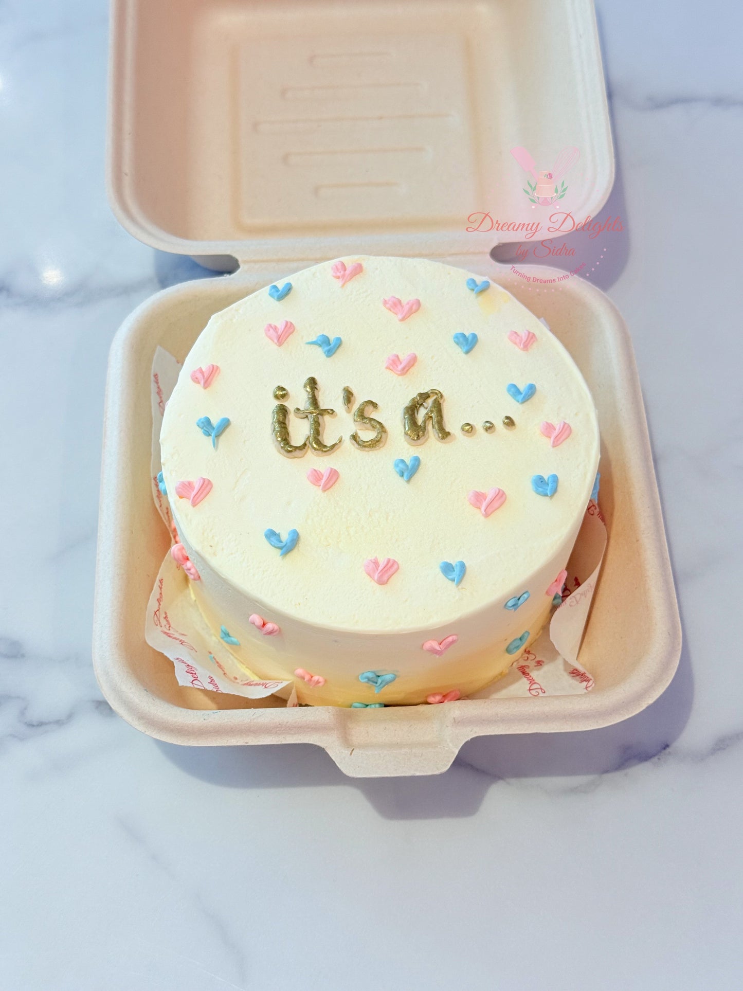 Gender reveal bento cake with pastel hearts and buttercream finish