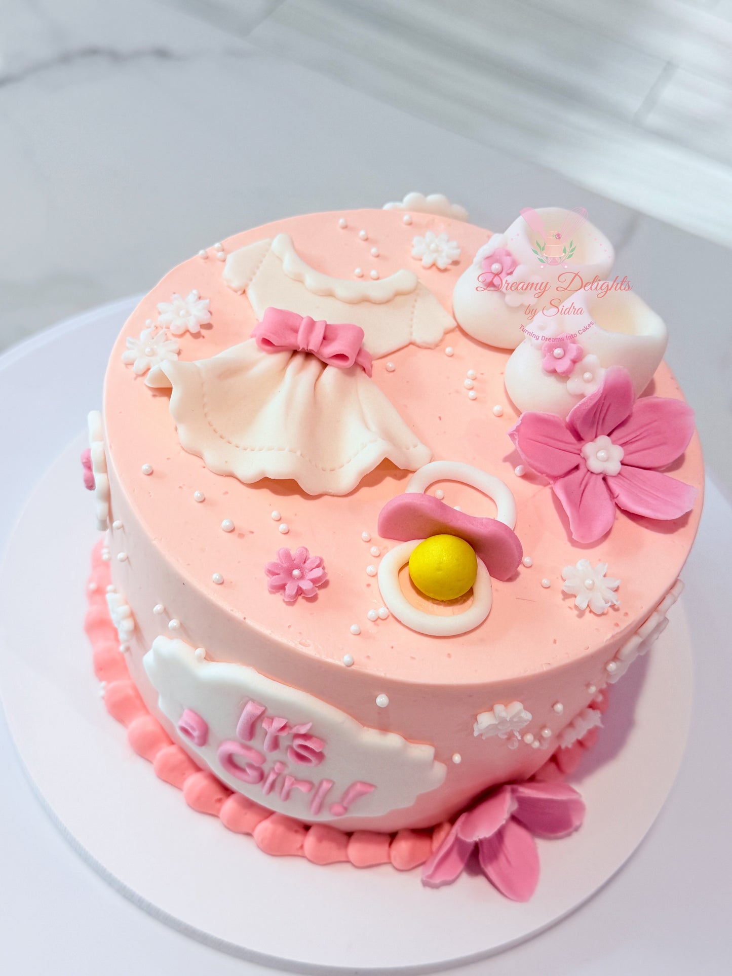 Its a girl baby shoes cake