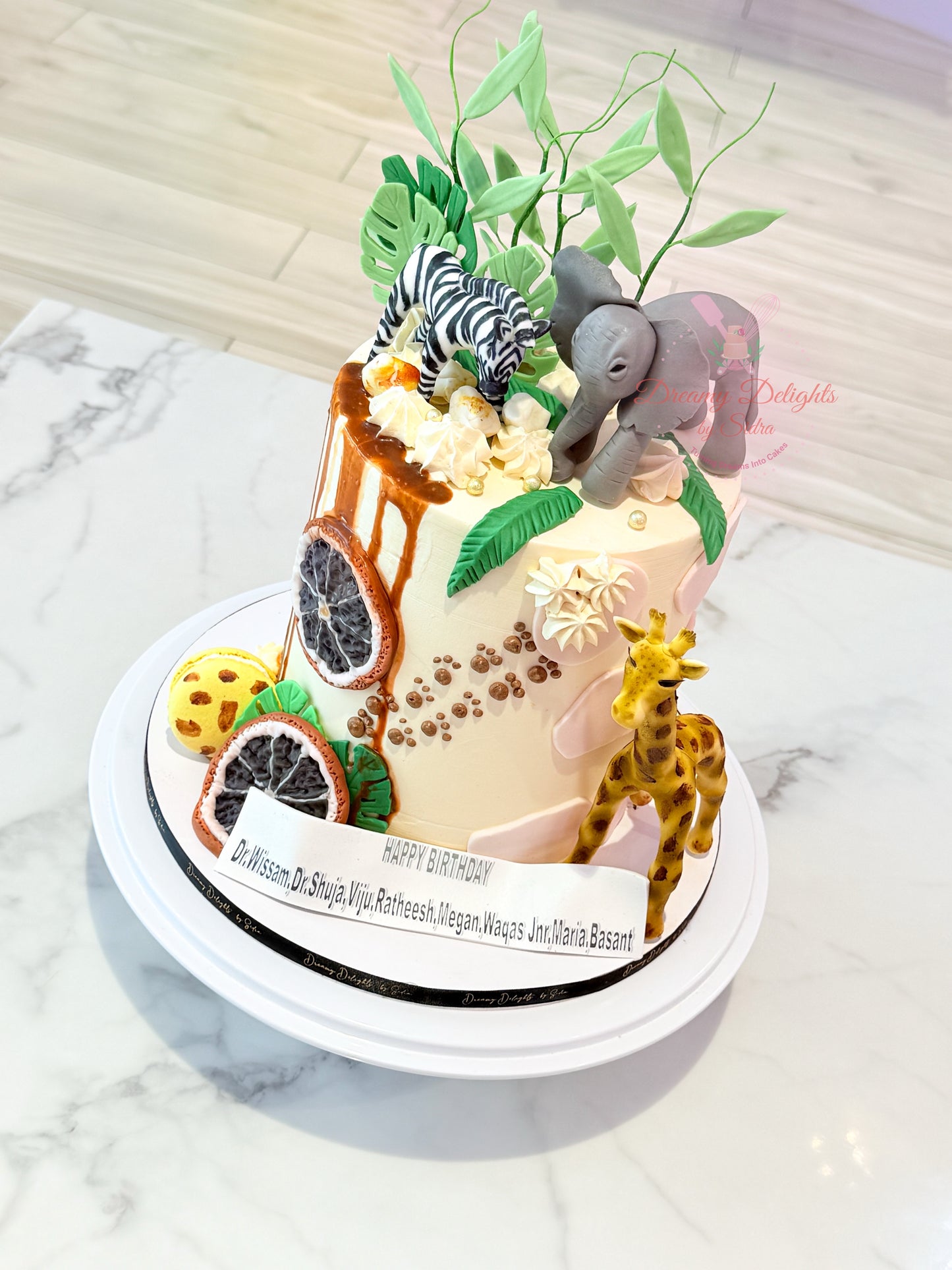 Decorative cake with animal figurines on a marble surface