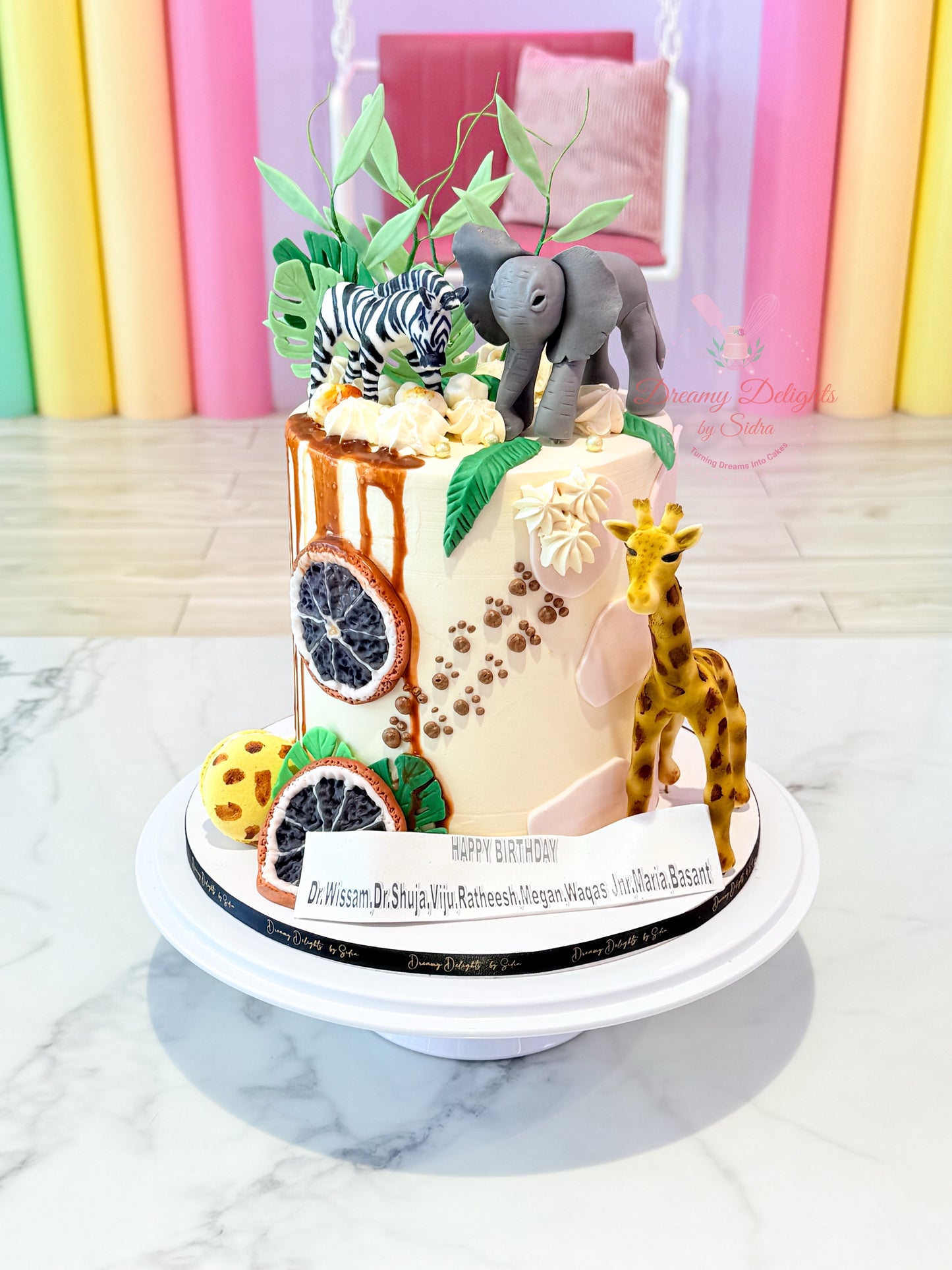 Decorative cake with animal figurines on a colorful background