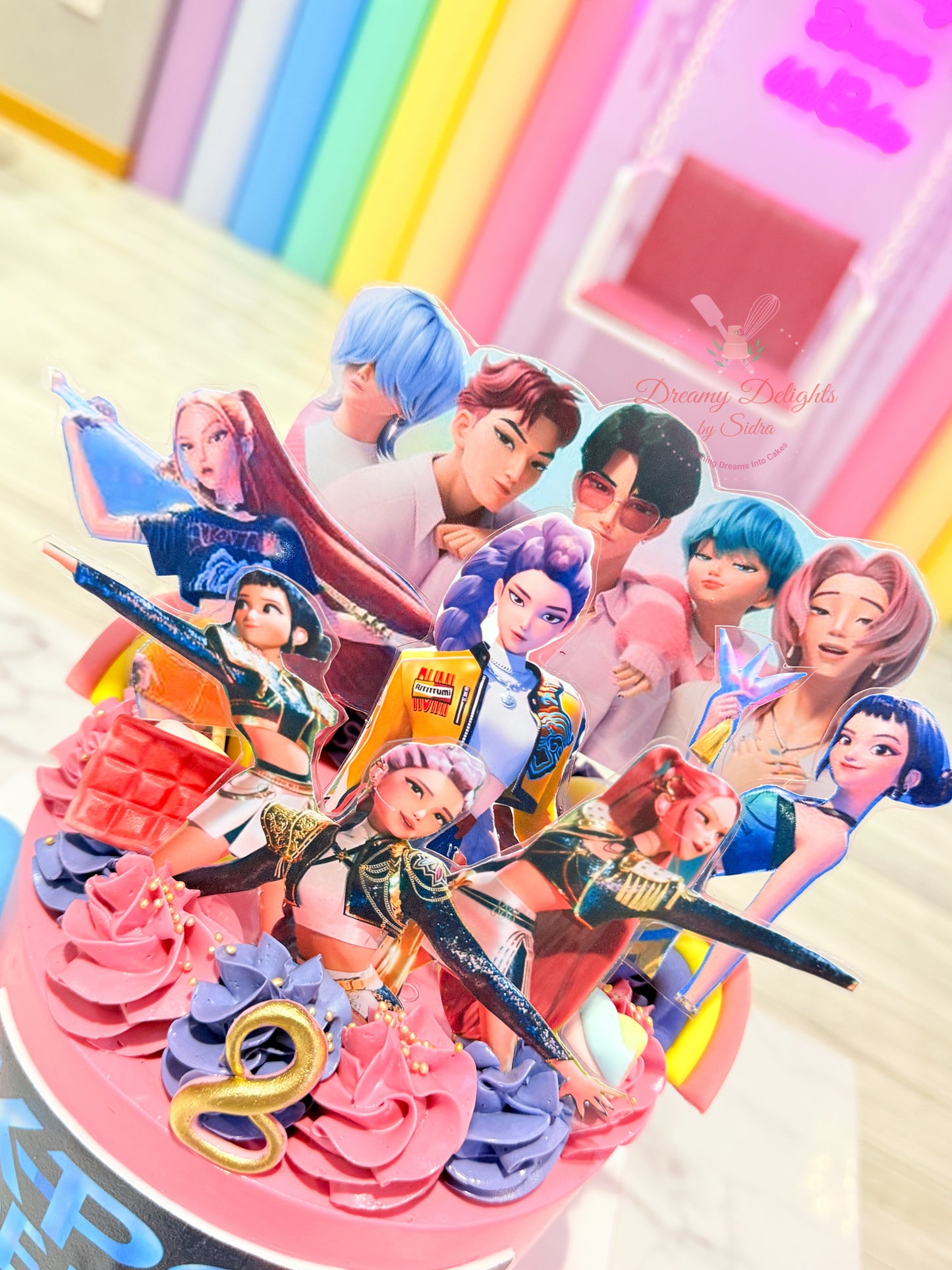 Colorful birthday cake with animated character figurines on a white background