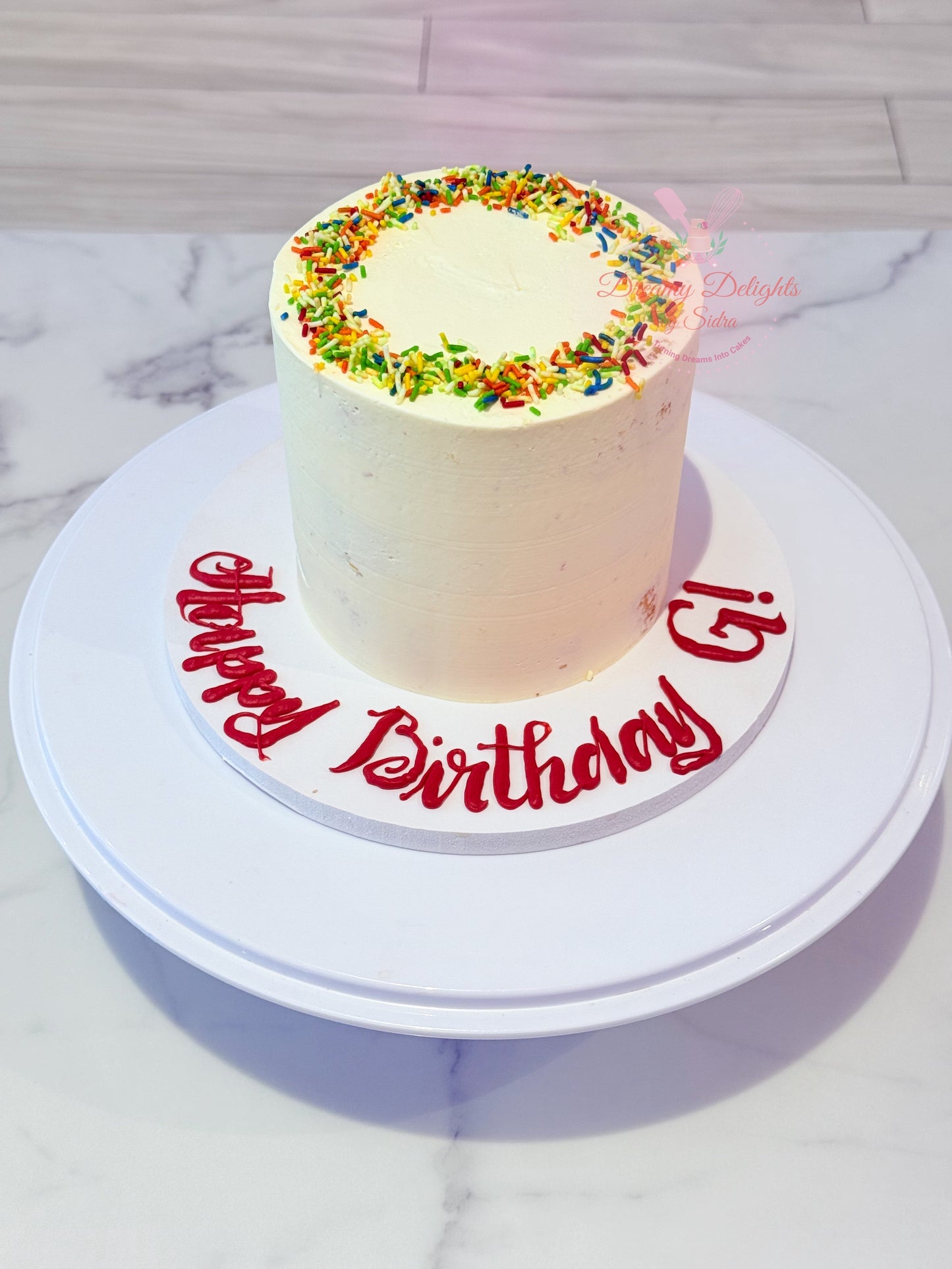 Simple buttercream sprinkles birthday cake with rainbow sprinkles and smooth frosting Dubai