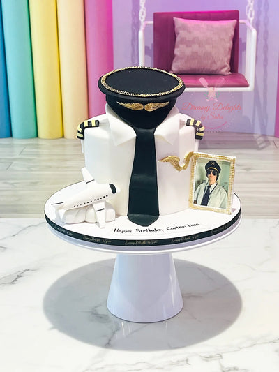 Pilot graduation cake Dubai — custom aviation cake with wings and uniform for pilot graduate by Dreamy Delights by Sidra