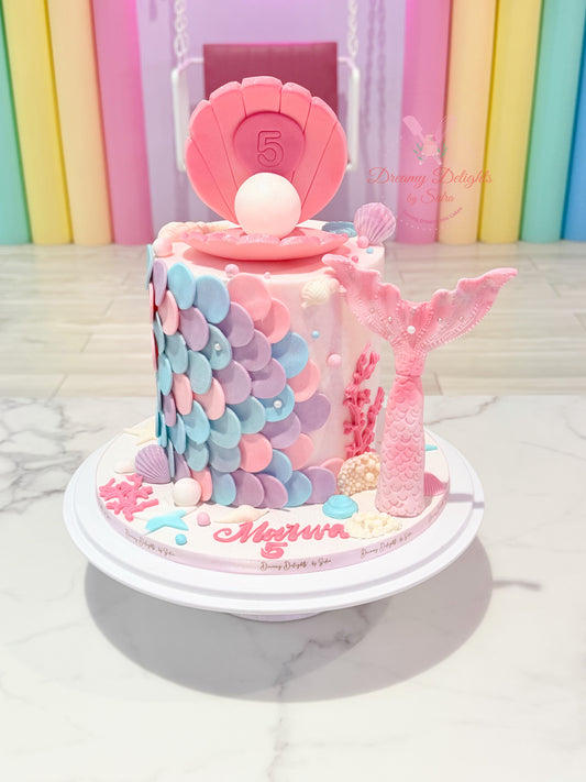 mermaid tail birthday cake Dubai with seashell topper and pastel scales