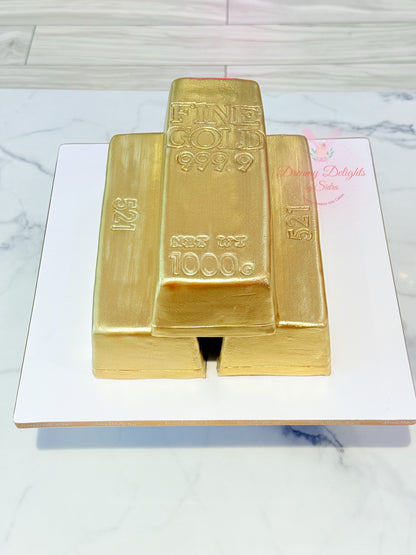Gold bar cake on a white marble surface