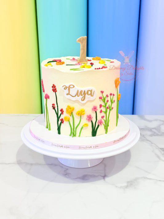Children's birthday cake with floral design and 'Luya' on a colorful background