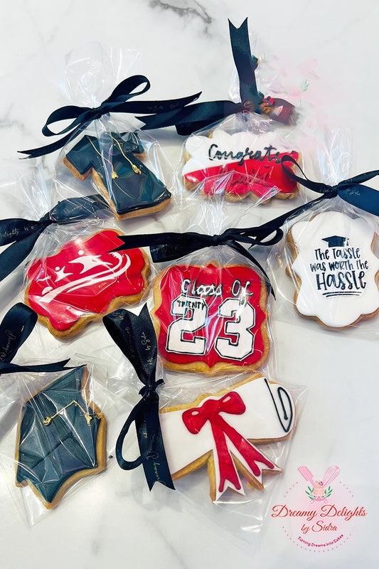 Custom decorated graduation cookies in Dubai with cap and scroll designs for convocation or school leavers party

