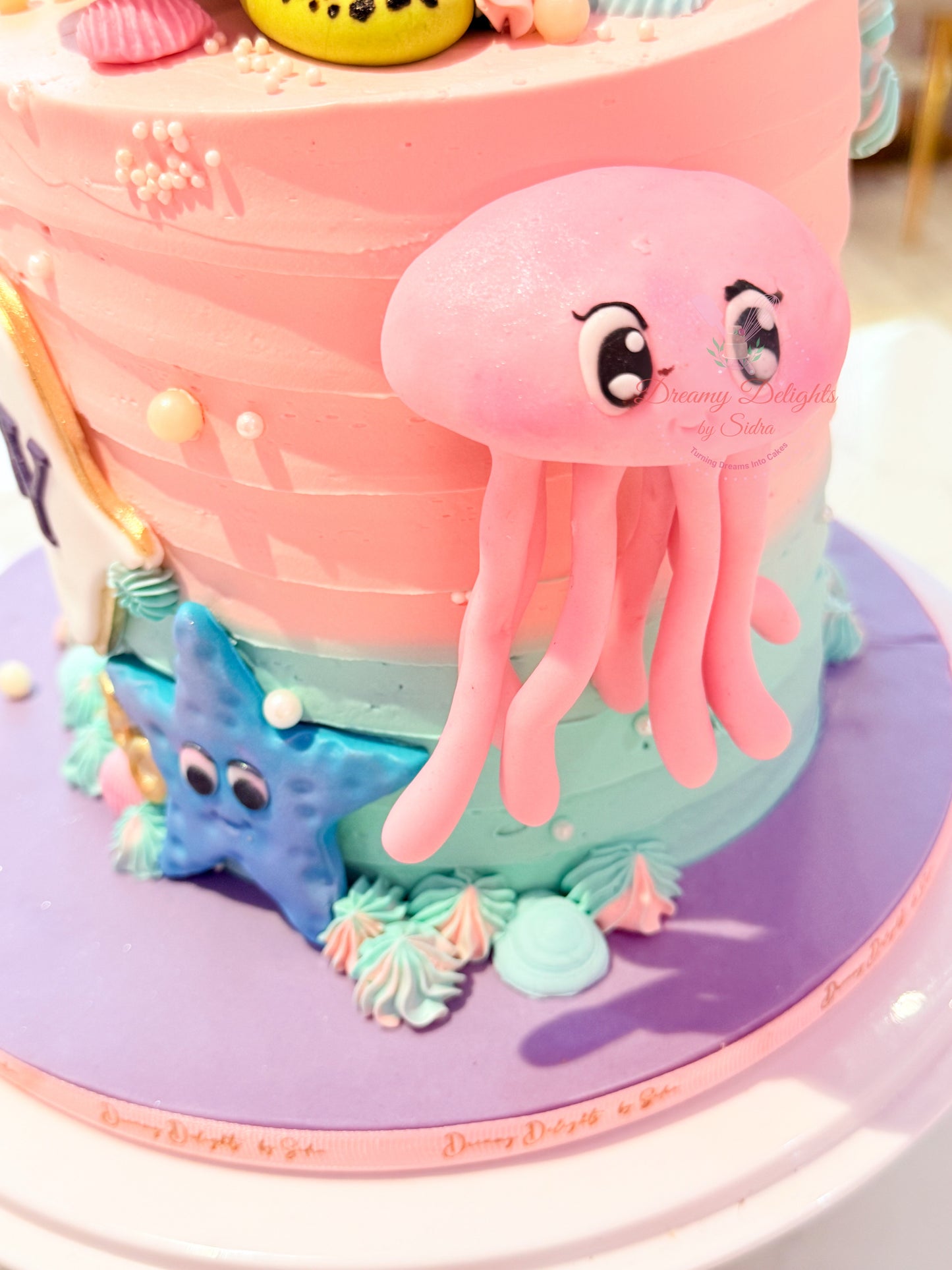 Colorful cake with a pink jellyfish and blue starfish decoration