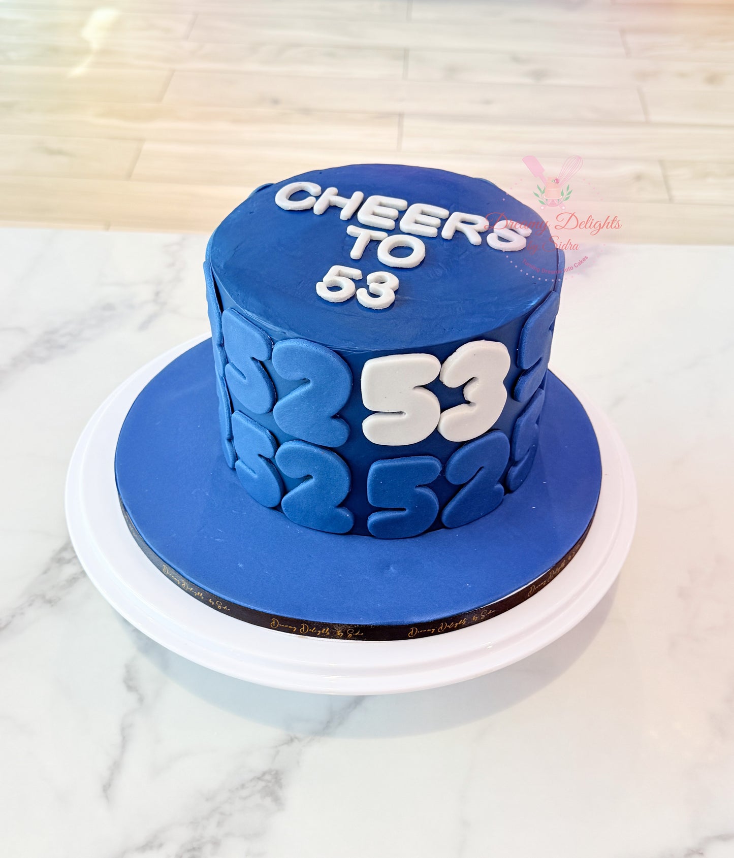 Blue age number birthday cake with bold 53 design for men celebration in Dubai