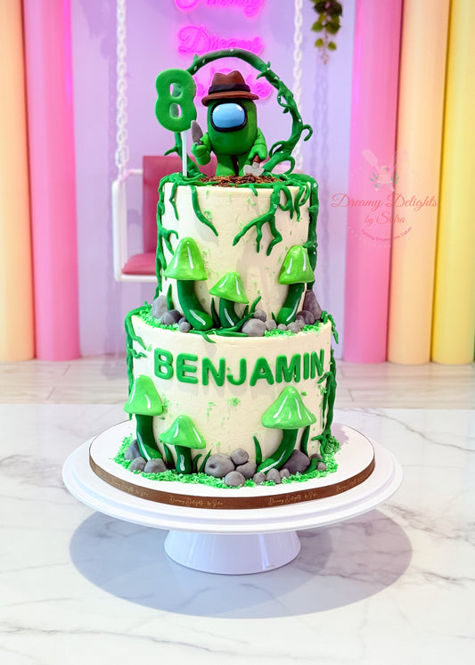 Two-tier birthday cake with green camouflage design and 'Benjamin' on a white stand.