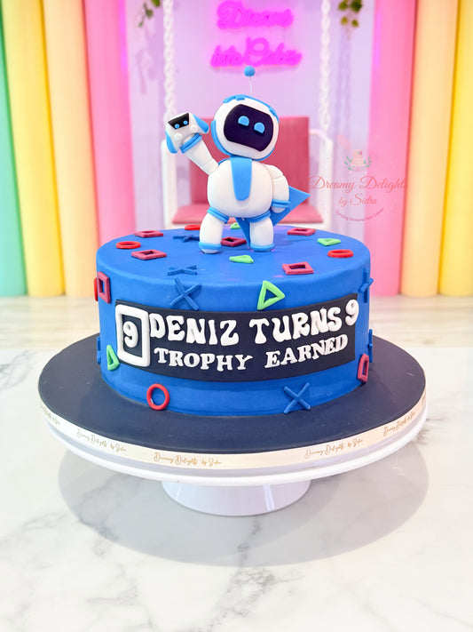 Personalized Astro Bot PlayStation birthday cake with gaming controller icons, custom name, and blue fondant design for boys in Dubai.