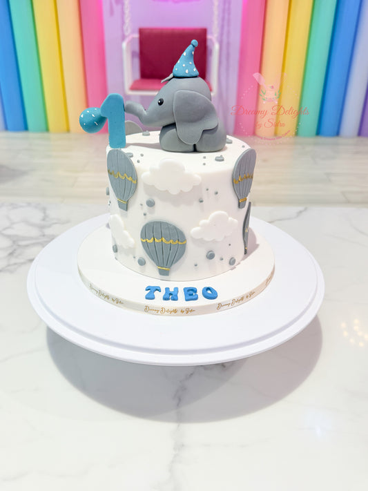 baby elephant first birthday cake Dubai with balloon theme and number one topper