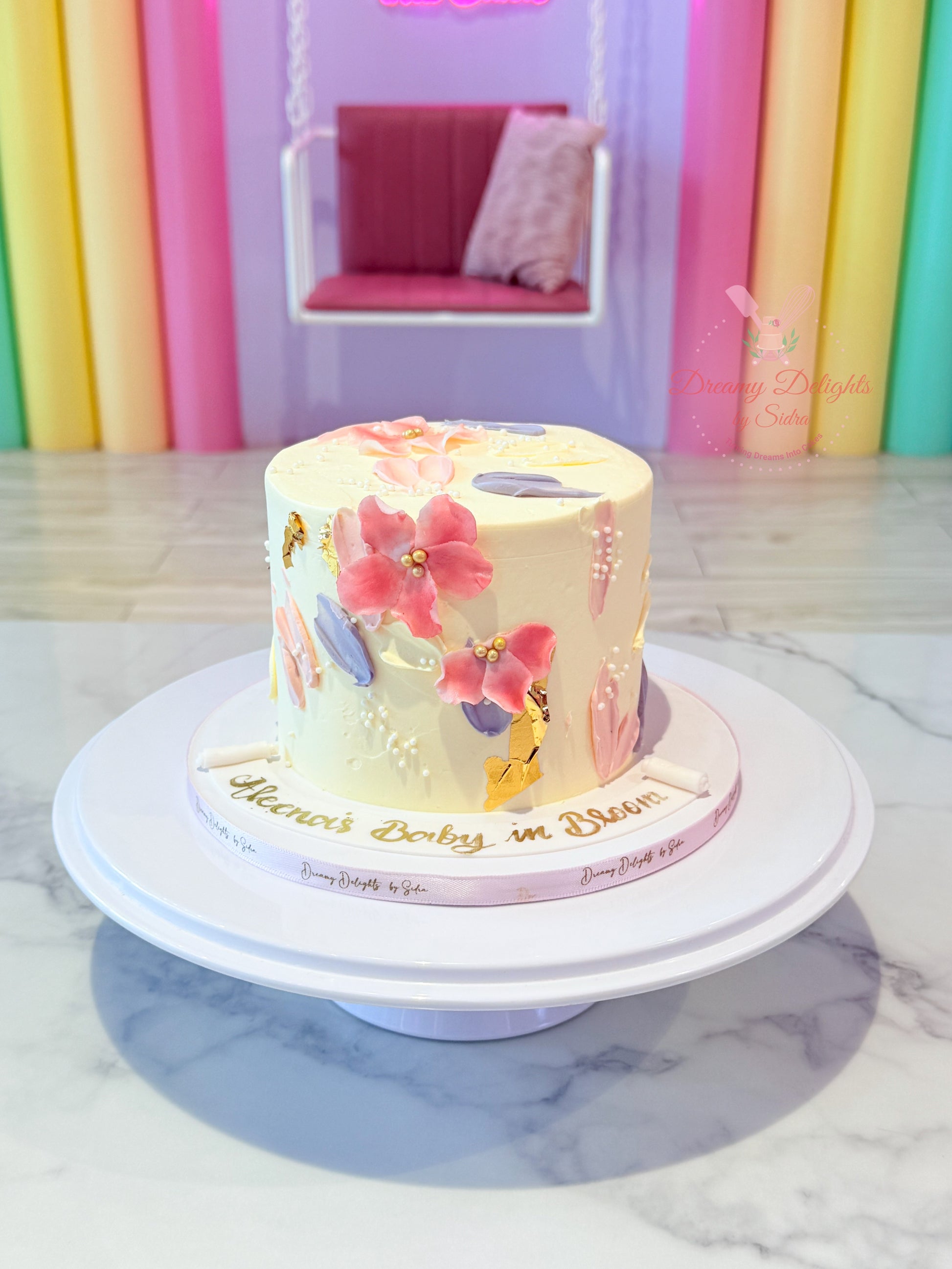 Decorative cake with floral designs on a marble surface with colorful background
