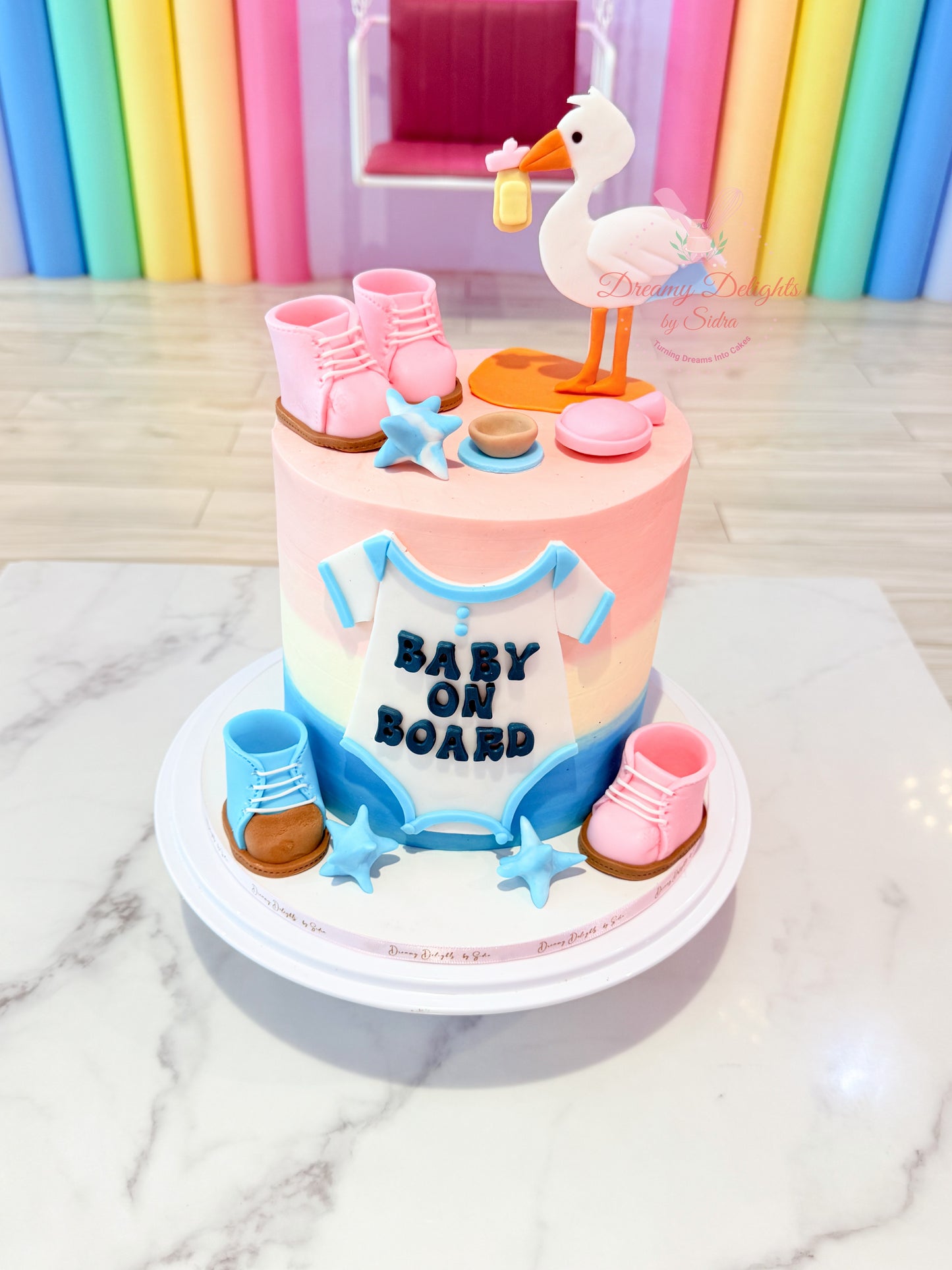 Baby on Board baby shower cake with stork design and pastel theme