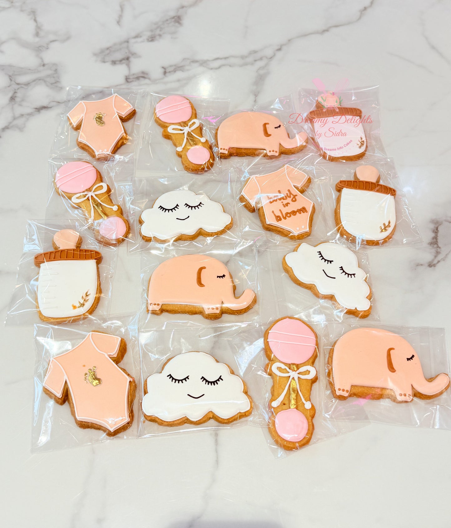 Elephant baby shower cookies with baby onesie and cloud designs Dubai