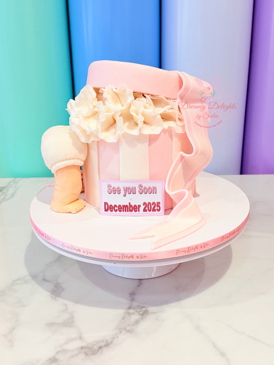 Baby shower gift cake Dubai designed as a pink baby outfit with ruffles and flowers by Dreamy Delights by Sidra
