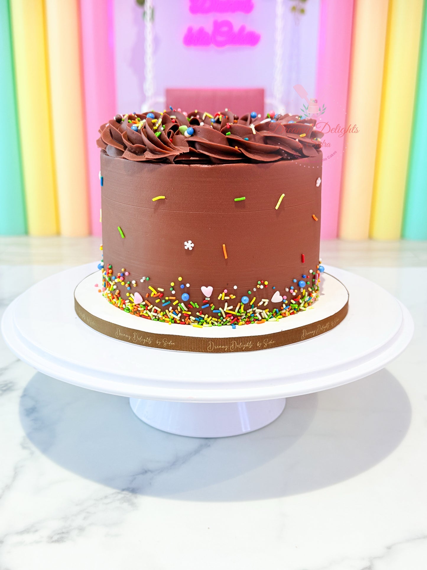 Belgium chocolate cake with smooth chocolate frosting and colorful sprinkles, classic chocolate cake in Dubai