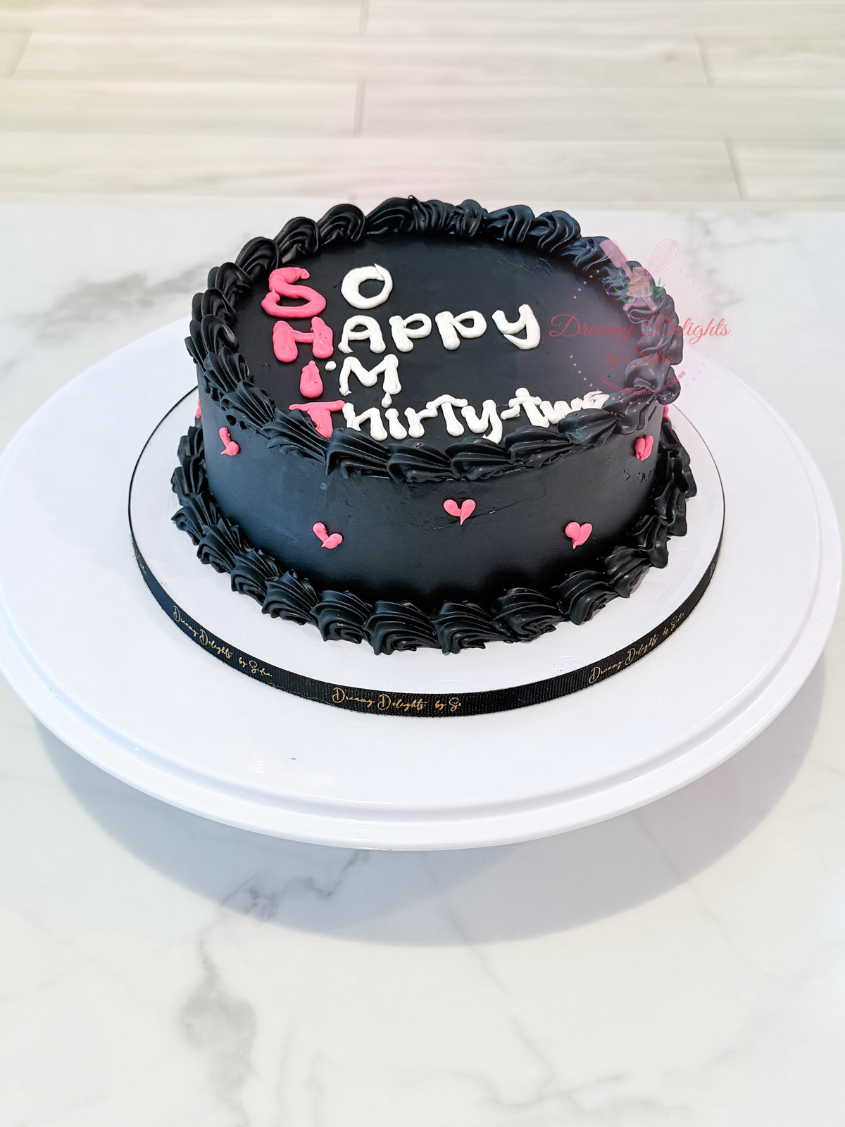 Black vintage birthday cake for her with pink and white lettering and decorative buttercream piping by Dreamy Delights by Sidra in Dubai