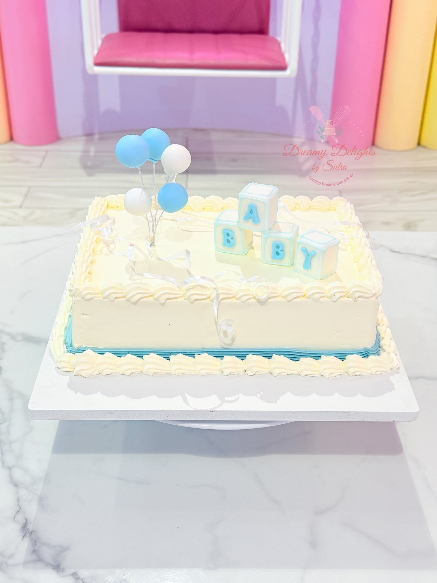 Blue Balloon Baby Shower Cake with baby block toppers and pastel buttercream design for boy baby shower celebrations in Dubai