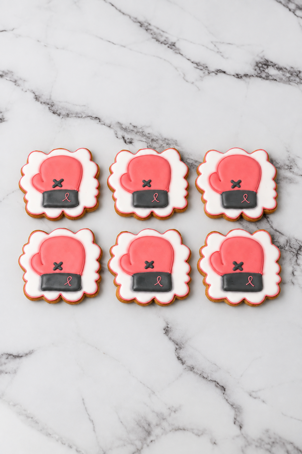 Breast cancer awareness boxing glove cookies with pink ribbons in Dubai