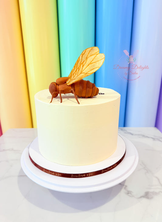 Cake with a bee decoration against a colorful curtain background