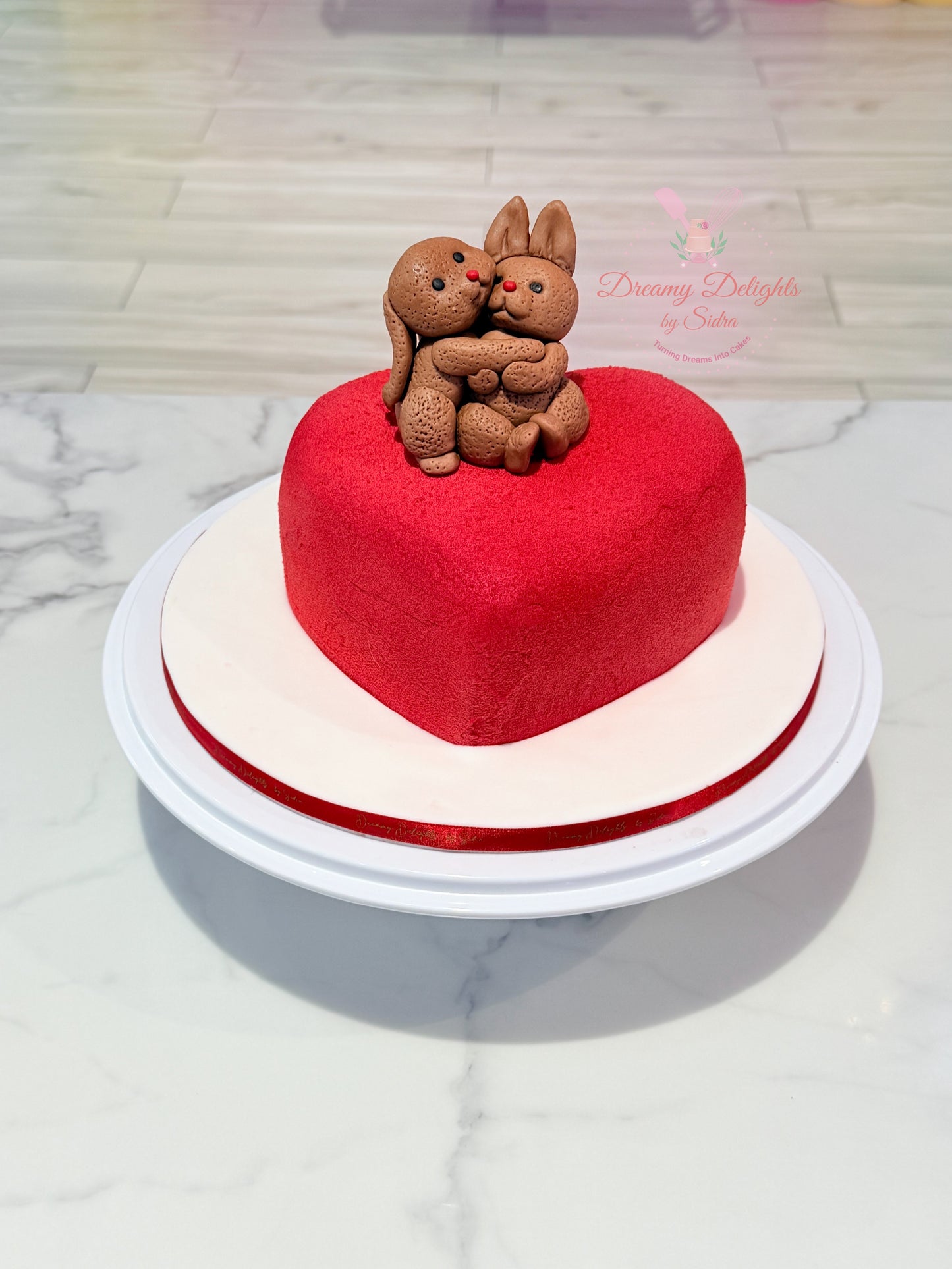 Bunny couple heart anniversary cake with romantic fondant design in Dubai