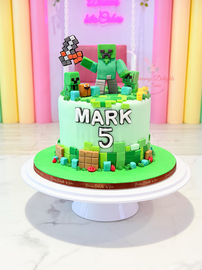 Minecraft-inspired cake for boys Dubai with green blocks, characters and personalised birthday details by Dreamy Delights by Sidra