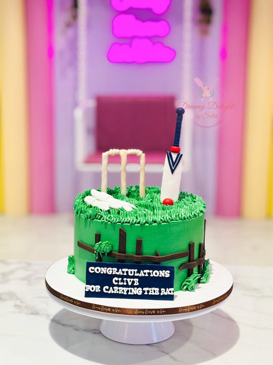 Cricket cake Dubai with a green cricket field, bat, wickets and cricket balls by Dreamy Delights by Sidra