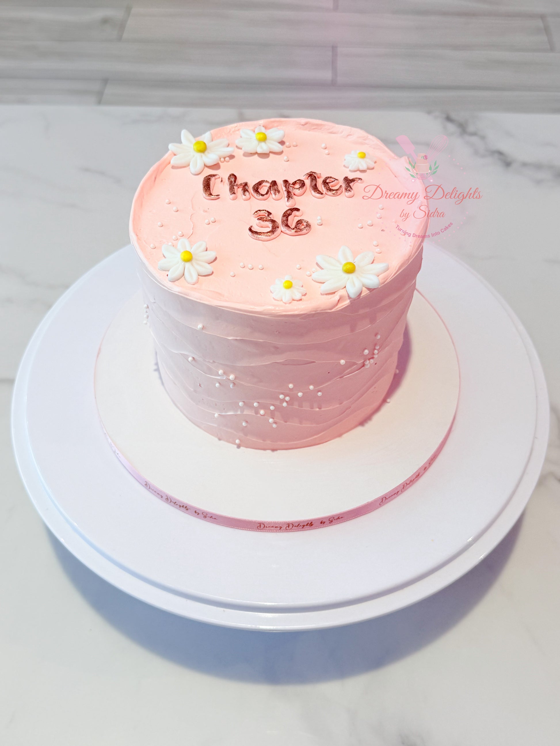 Minimal buttercream cake with chapter 36 design and soft pink finish for her birthday in Dubai
