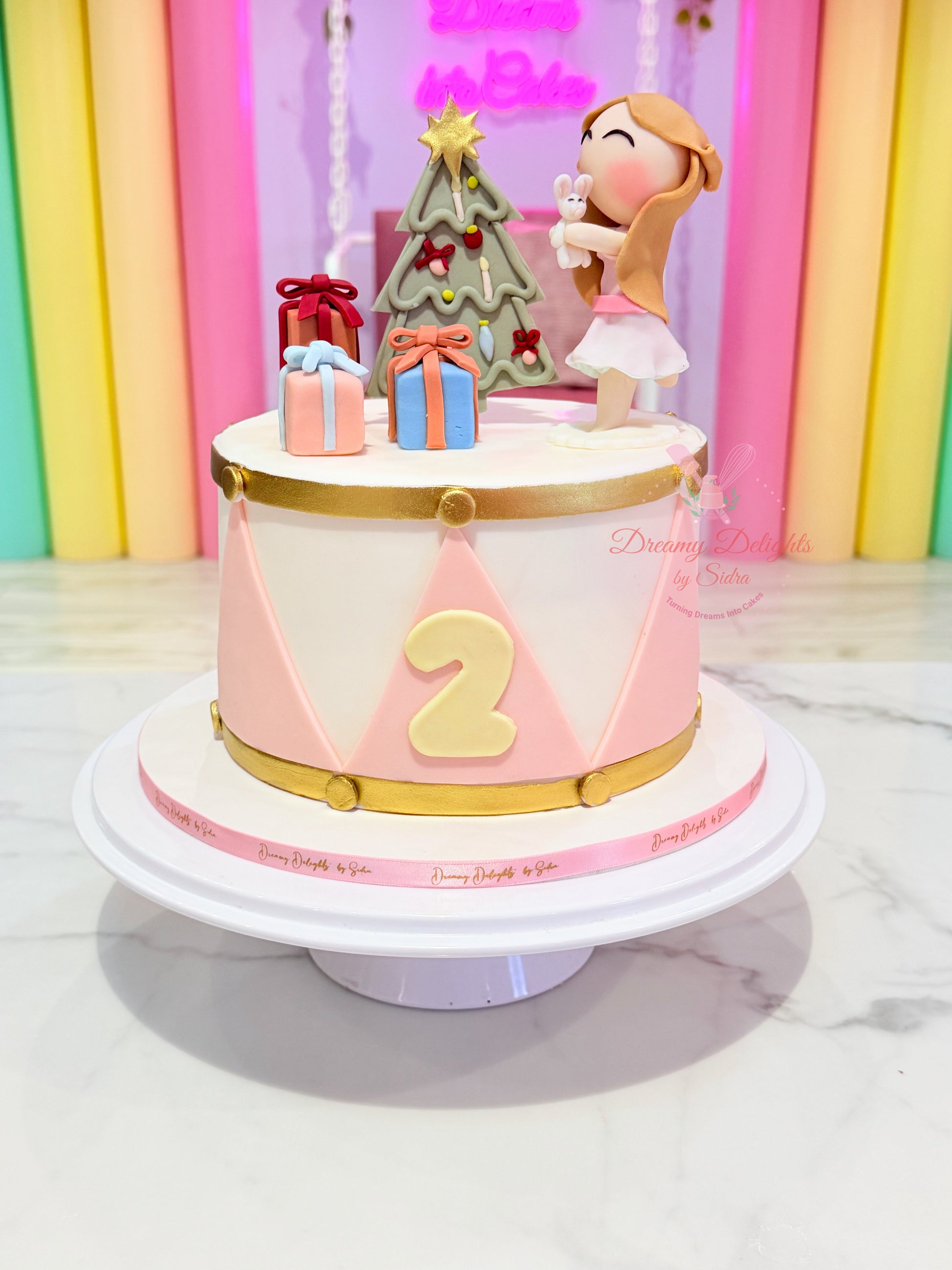 Christmas birthday girl cake with festive decorations and custom age topper in Dubai