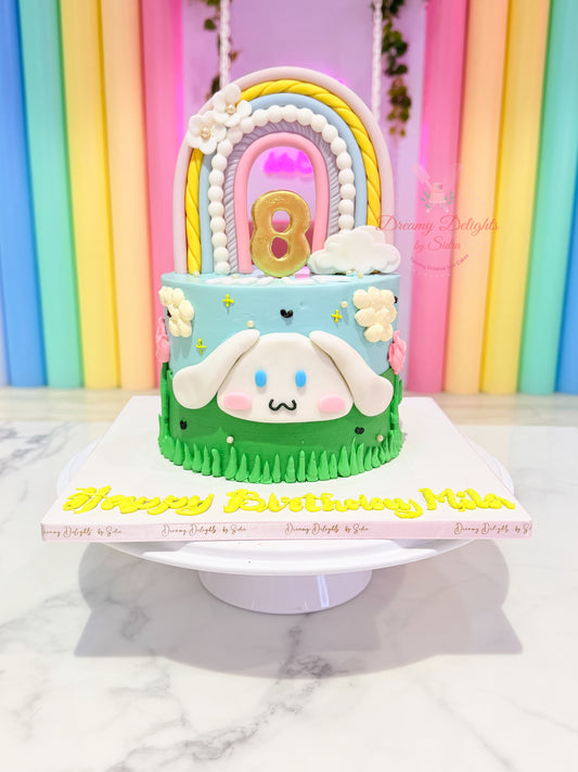 Cinnamoroll birthday cake with rainbow topper, pastel flowers, cloud decorations, and personalised name by Dreamy Delights by Sidra in Dubai.