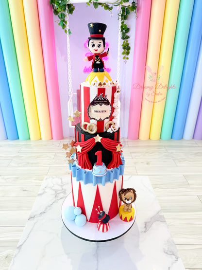 Decorative cake with circus theme in front of a colorful curtain