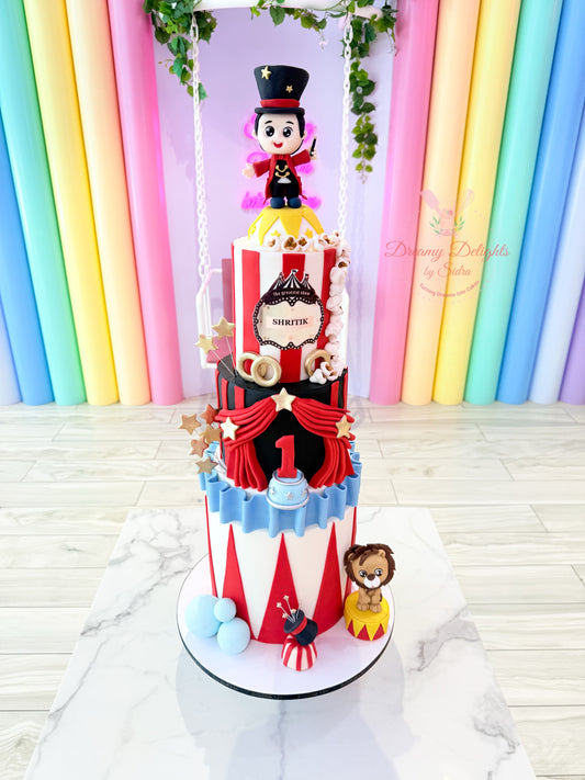 Decorative cake with circus theme in front of a colorful curtain