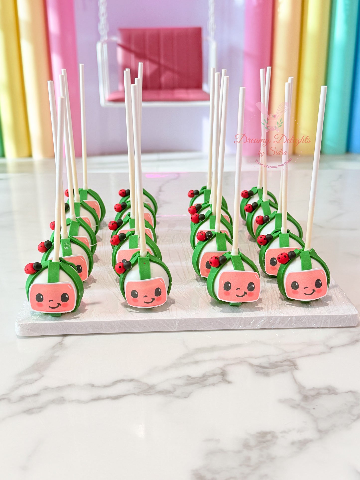 Cocomelon themed cake pops with edible decorations for kids birthday parties and celebrations in Dubai.