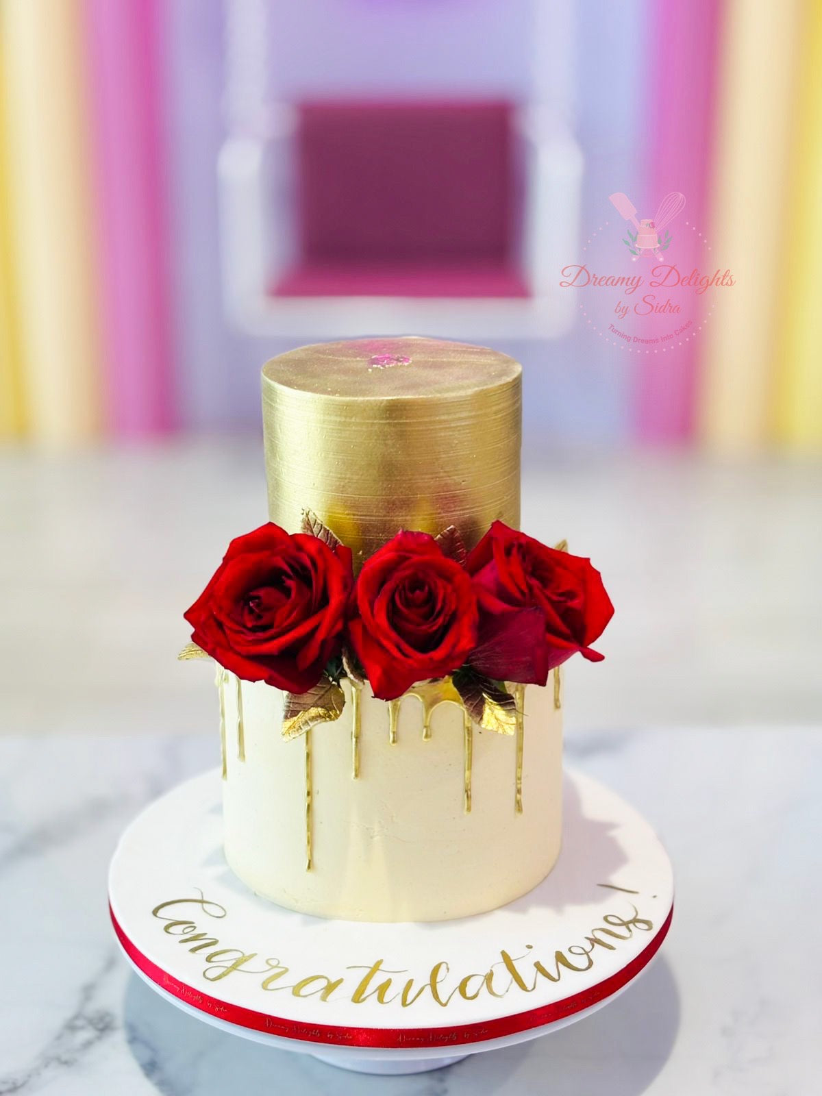 Congratulations red roses wedding anniversary cake with gold drip design in Dubai