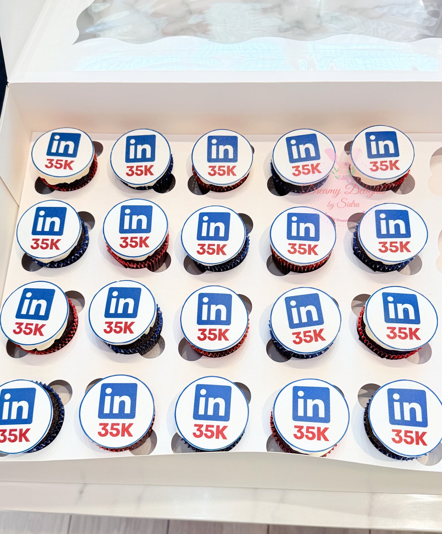 Corporate achievement cupcakes with custom branded edible toppers for office celebrations in Dubai