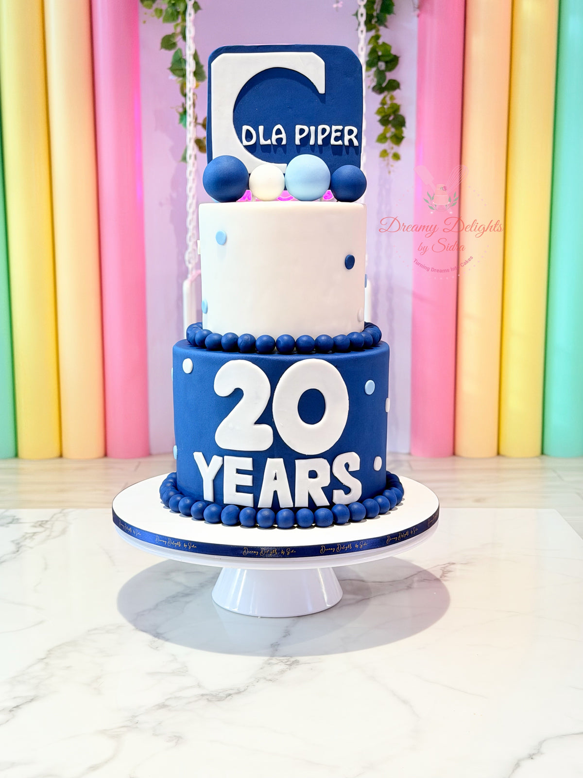 20 years corporate cakes Dubai design in blue and white by Dreamy Delights by Sidra