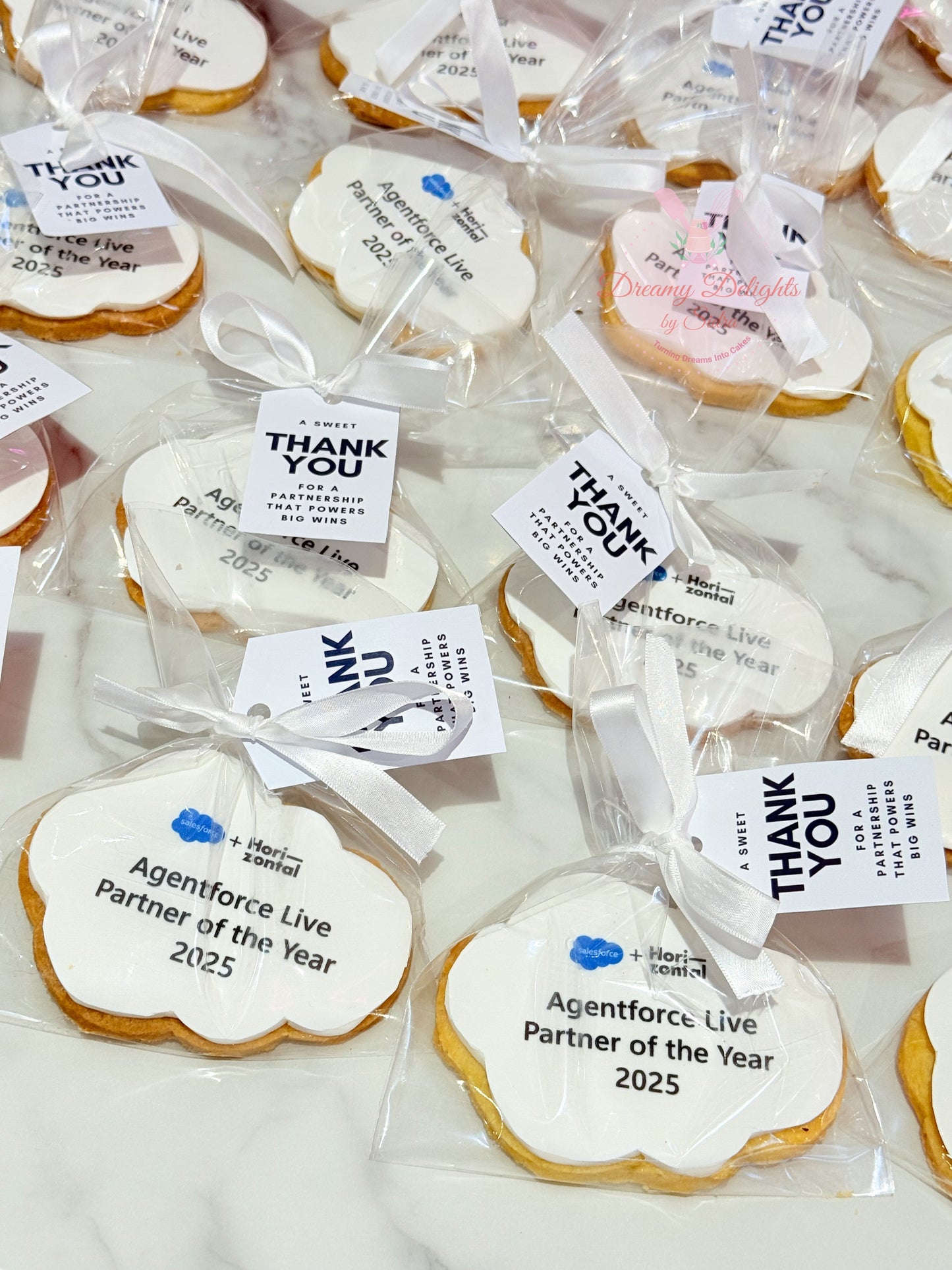 Shaped corporate logo cookies in Dubai with edible print and personalized tag