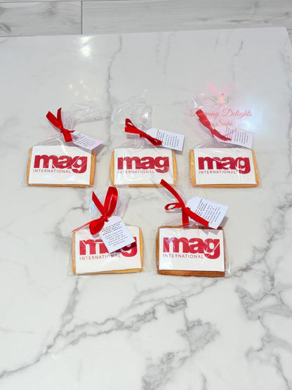 Custom corporate logo cookies individually wrapped with red ribbons and personalized gift tags for business events and client gifting in Dubai.