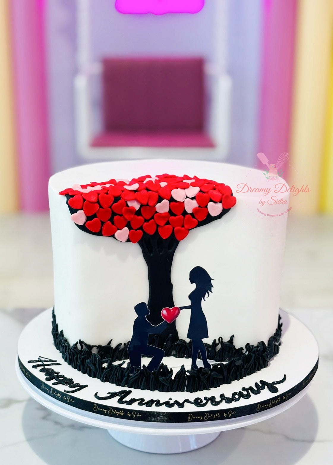 Couple wedding anniversary hearts cake with romantic silhouette design in Dubai
