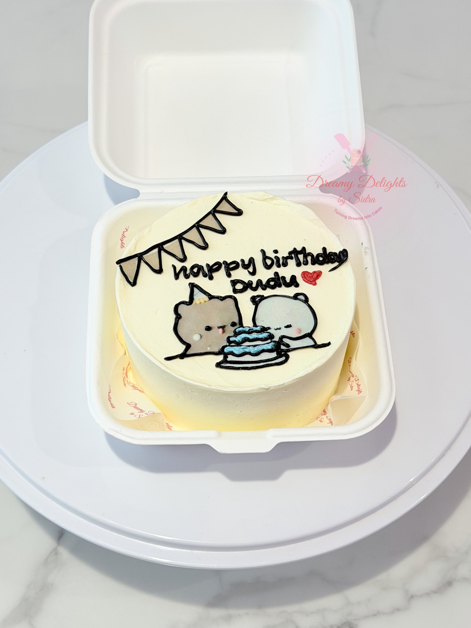Cute cartoon birthday bento cake with hand-piped characters, birthday cake illustration, and personalized message in Dubai.