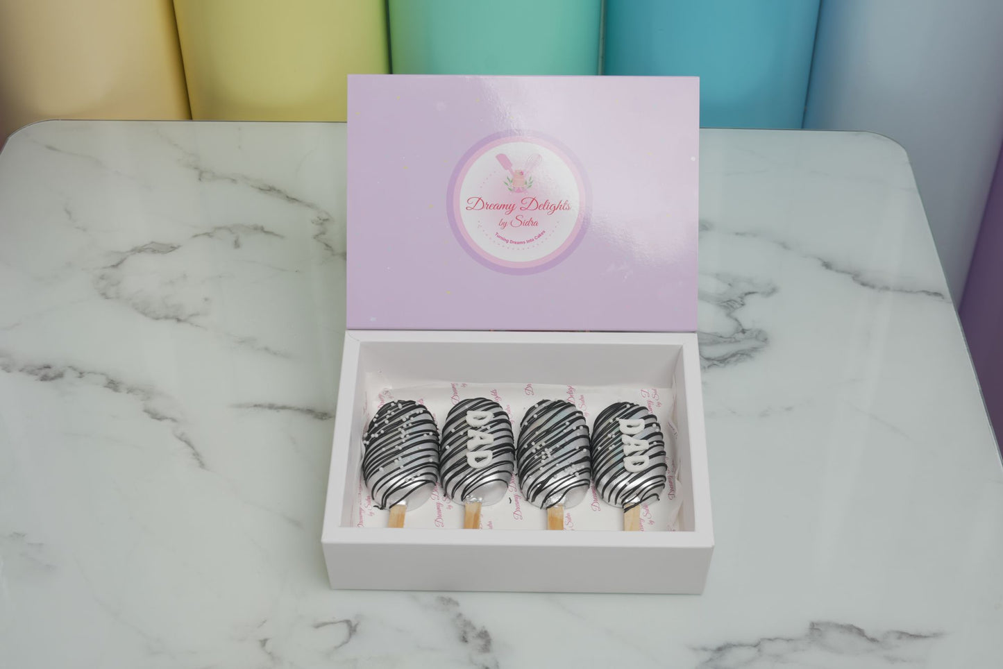 Luxury Dad Cakesicles with silver chocolate drizzle and Father's Day decorations, perfect Father's Day gift and dessert in Dubai for 2026