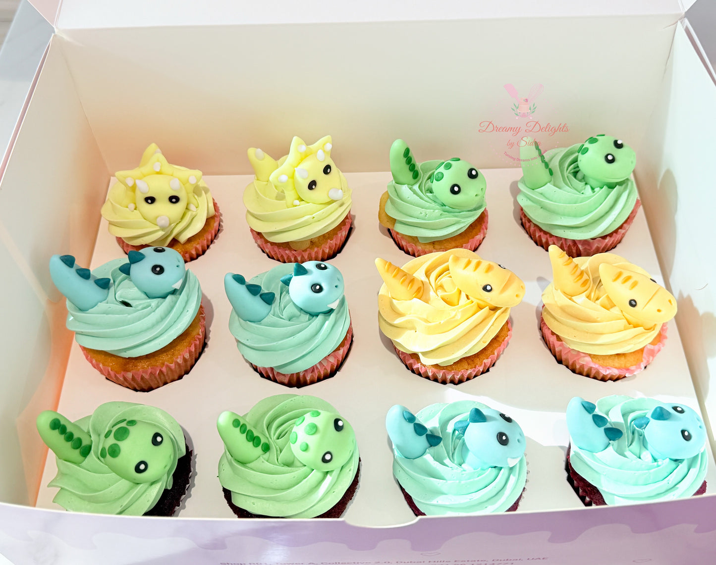 Dinosaur themed cupcakes with pastel frosting and cute fondant toppers for kids birthday parties
