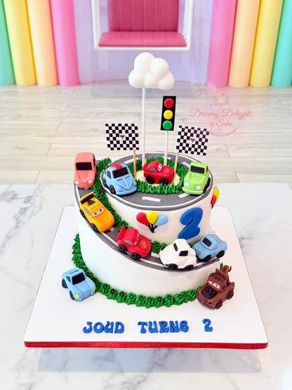 Disney Cars race track birthday cake with edible fondant Lightning McQueen, Mater, racing cars, and personalized name for boys in Dubai.