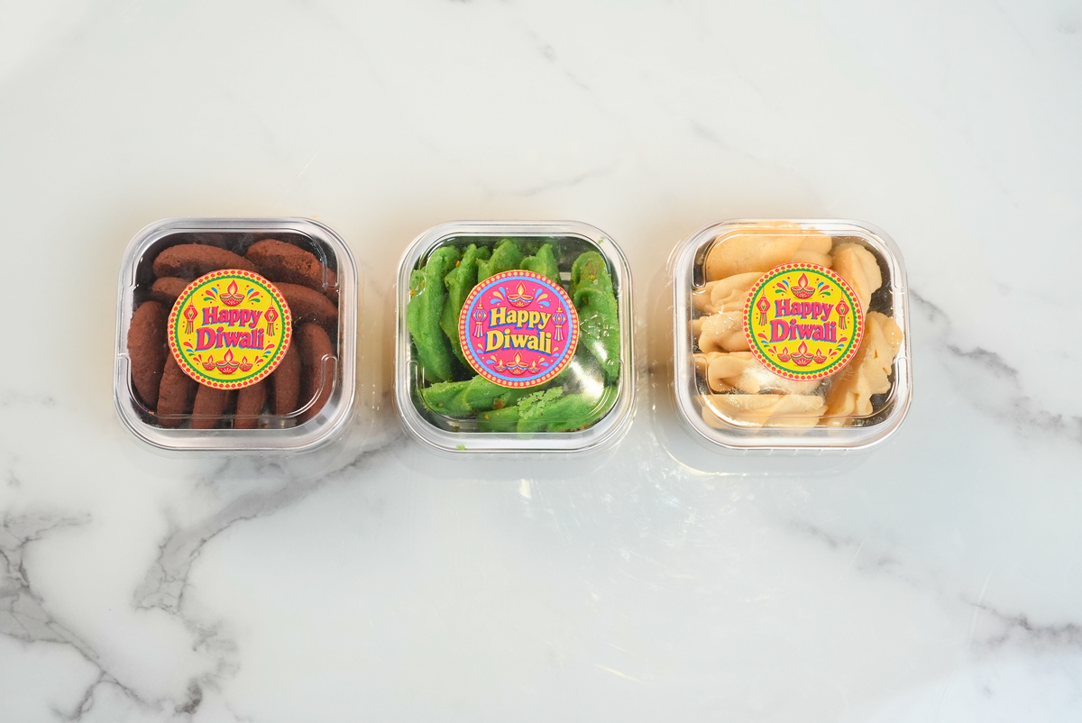 Diwali cookie gift set with three varieties of chocolate, green and golden cookies in festive packaging by Dreamy Delights by Sidra in Dubai