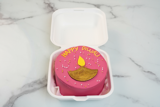 Pink Diwali Diya Bento Cake with golden diya decoration and Happy Diwali lettering by Dreamy Delights by Sidra in Dubai